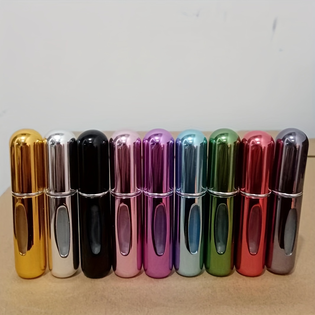 

A Set Of 9 Mini Perfume Sample Bottles, Each Holding 5ml, In A Shiny Golden Material, With Refillable Bottoms For Repeated Use, Perfect For Travel.