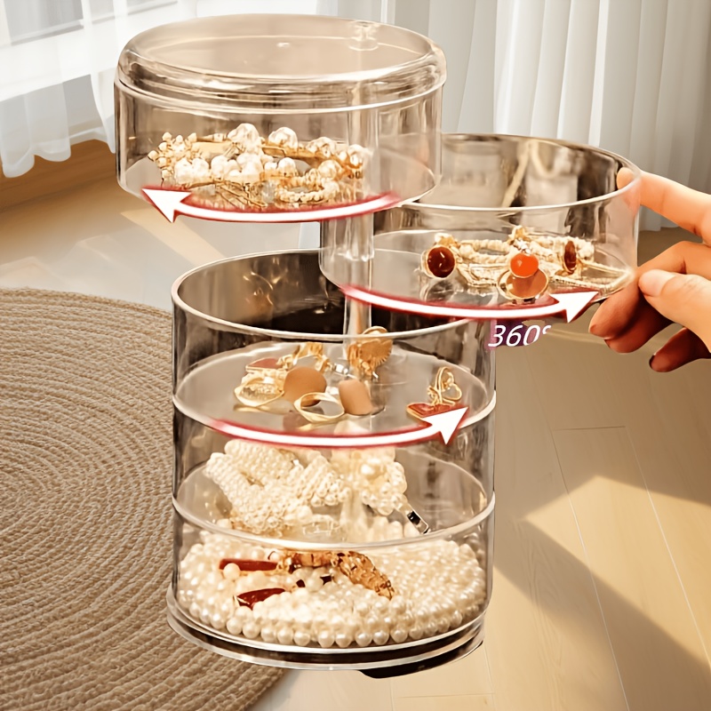 

Une boîte de rangement de bijoux transparente rotative - un organisateur multi-couches de style princesse pour cheveux et accessoires, en plastique .