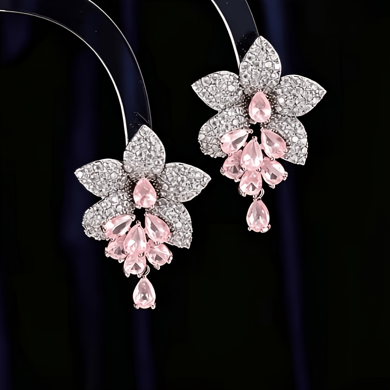 TEMU Un di orecchini a perno con design intarsiati con zirconia rosa o gialla
