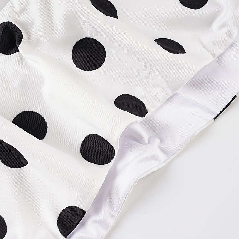 A Beach Vacation Outfit Featuring a Color-Blocked Polka Dot Bikini Set, with a Sexy Tie-Front Crop Top And Ruffled Shorts, Perfect for Seaside Holidays