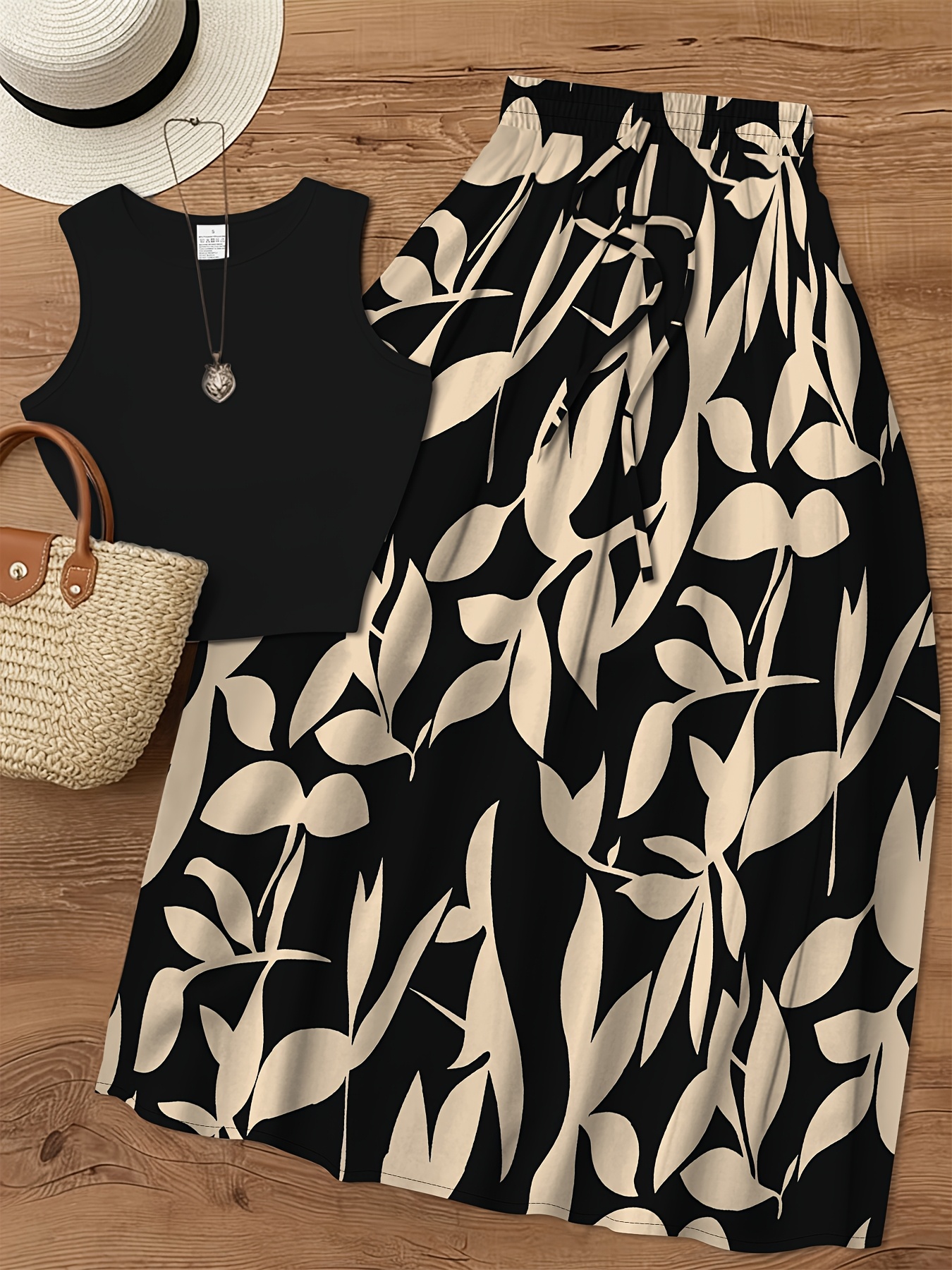 item picture a two piece set featuring a 2  stylish and elegant with a casual   the set   a   color fitted short sleeve round neck tank top and a skirt with a floral leaf pattern   a line style this new womens casua