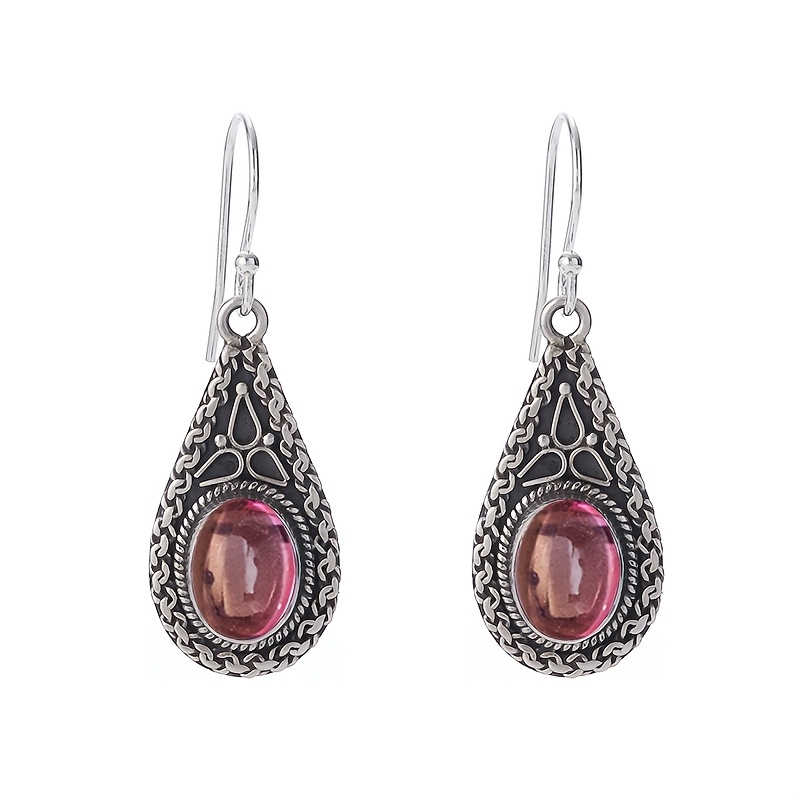 A Pair Of Bohemian-style Teardrop Earrings, With Oval-shaped Pink Accents, Perfect For Women To Or