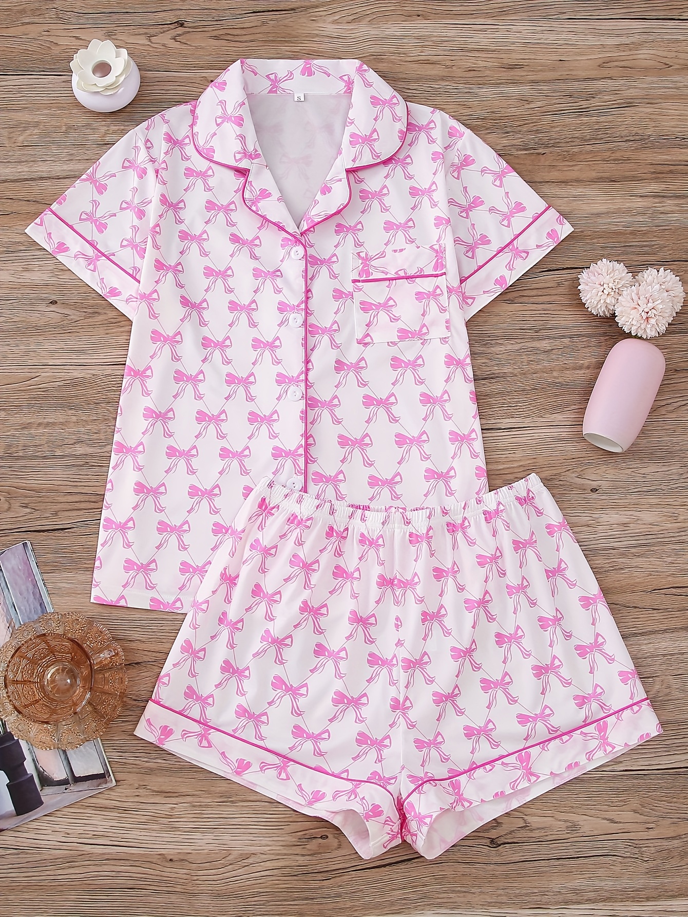 a set of pink bow themed womens casual wear including a short sleeved cardigan and elastic pants suitable for casual outdoor wear and pajamas throughout the year