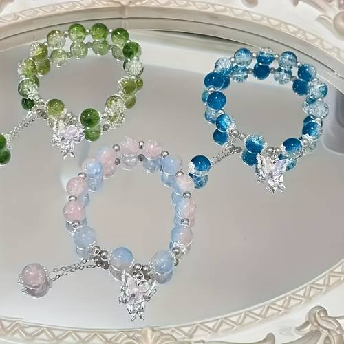 a and elegant glass bead bracelet with a pendant