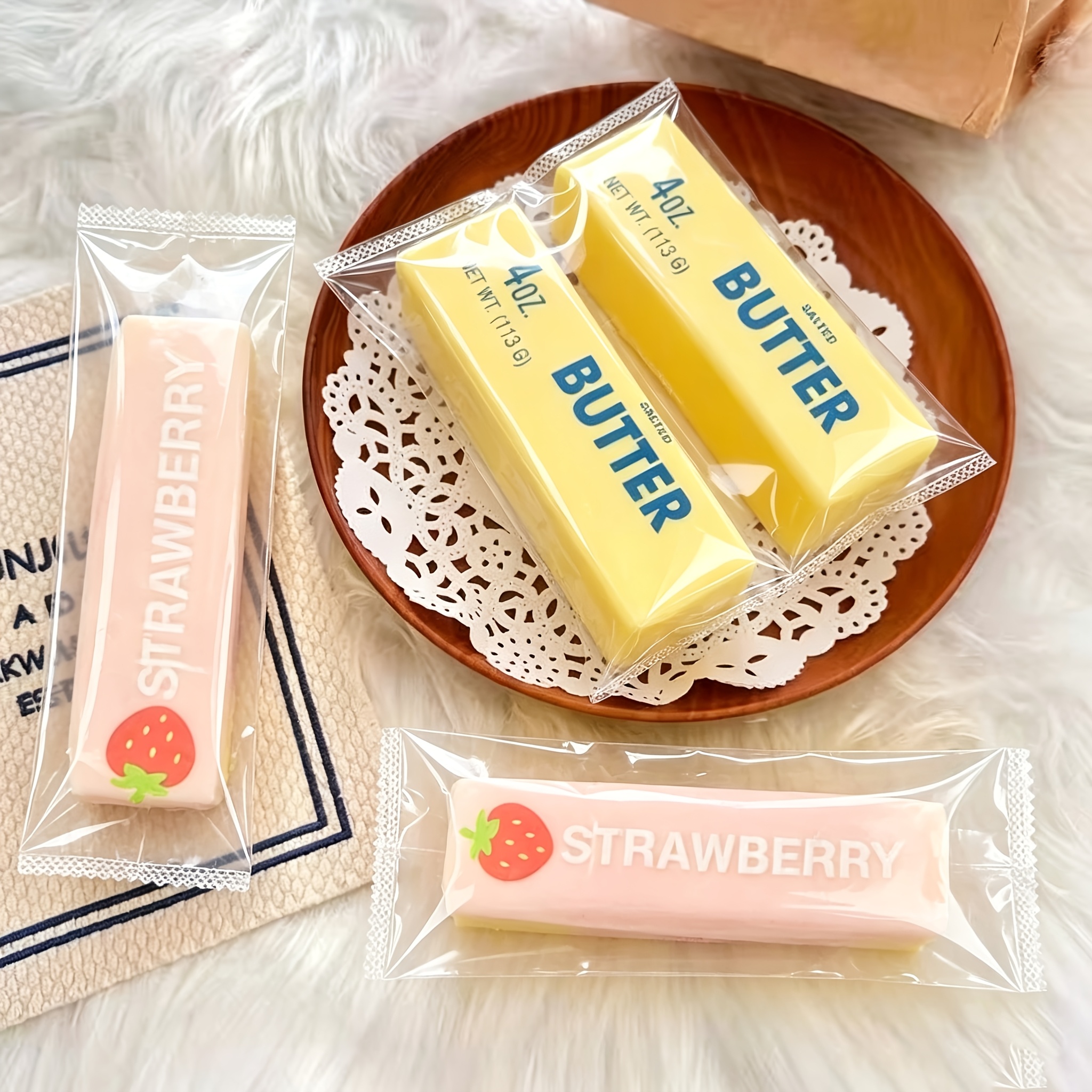 a pair of colorful elastic bouncing bread toys in pink and yellow including butter sticks and strawberry butter sticks   childrens party prizes awards quirky squeezable   bag fillers and classroom rewards random colors