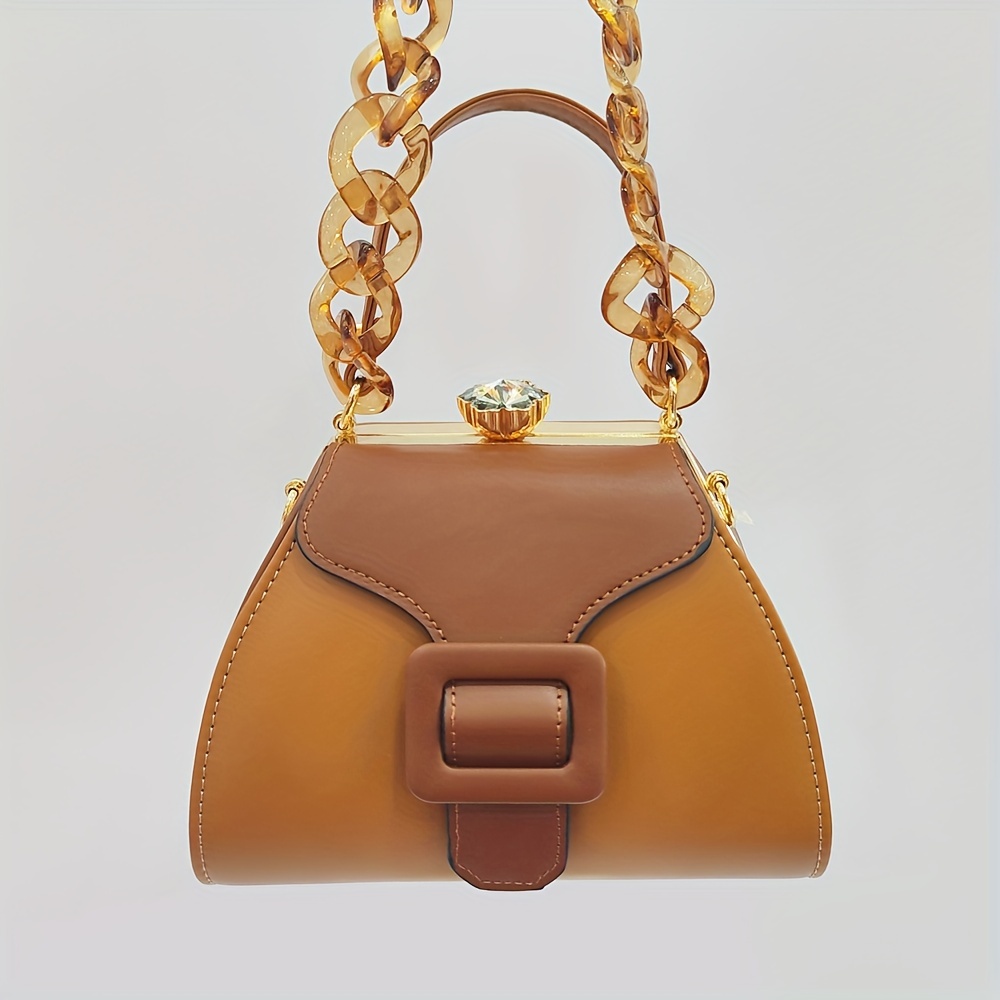 Stylish Two-Tone Round Handbag Made of Durable, Featuring a Detachable Acrylic Chain And Snap Closure. This Versatile Handbag Is Perfect for Both Parties And Everyday Use.