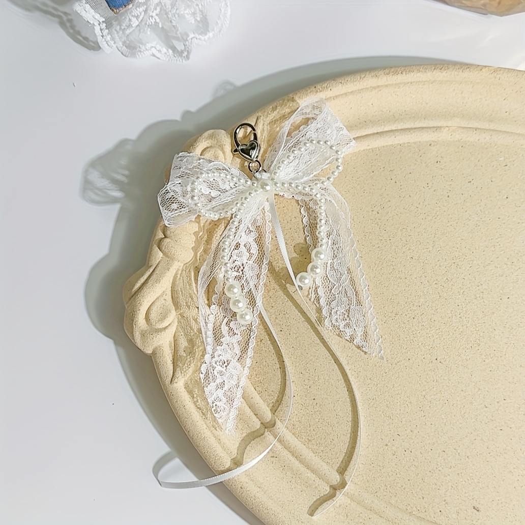Image of Elegant Artificial Pearl Bow Keychain - A Stylish Alloy Design, Perfect For Backpacks And Phone Cases, Making It An Ideal Birthday Gift For Women