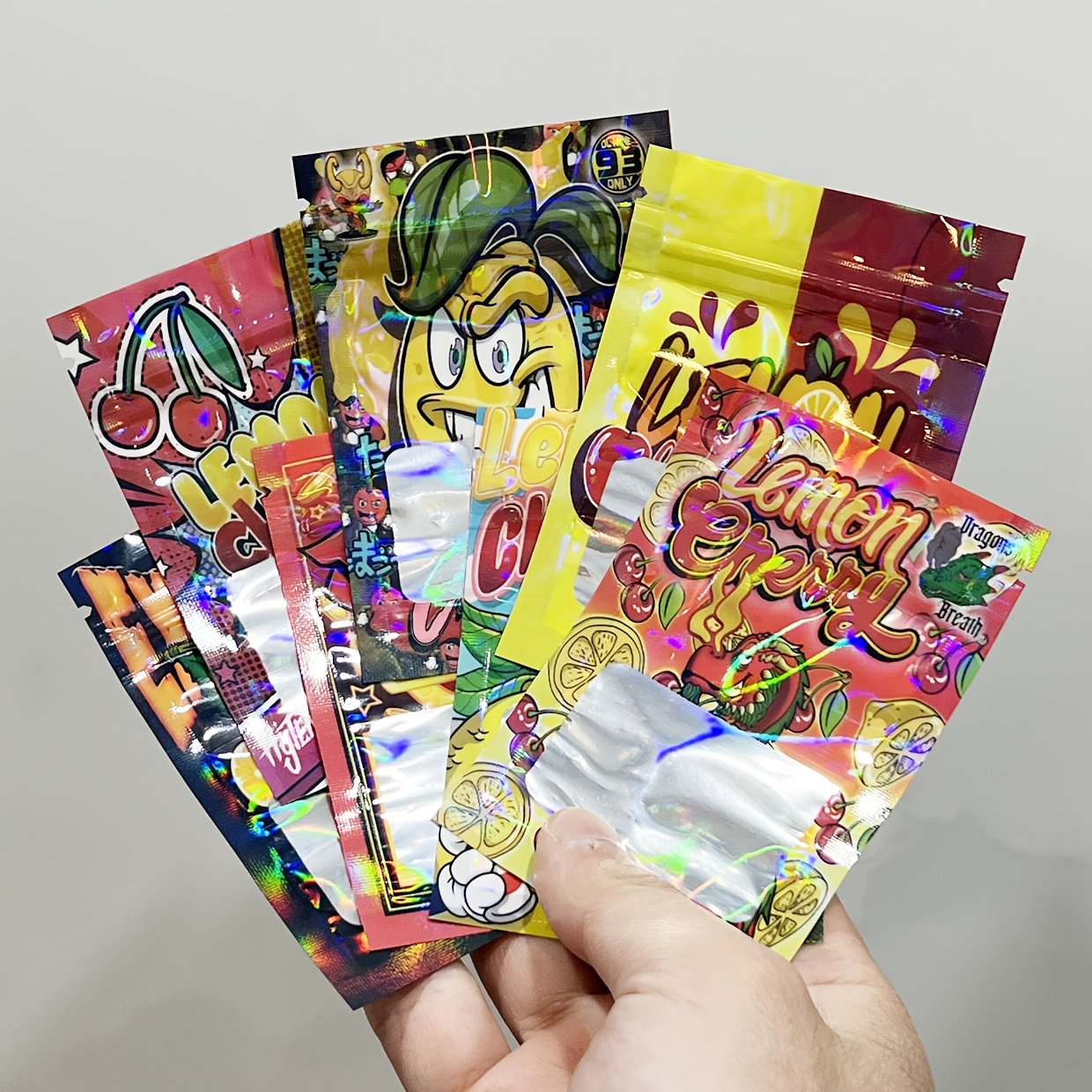 E-shop 100 Stück Cartoon-Design Holographische Laser-Mylar-Beutel – Geruchsdichte Wiederverschließbare Platzsparende Beutel mit Gemischten Mustern,