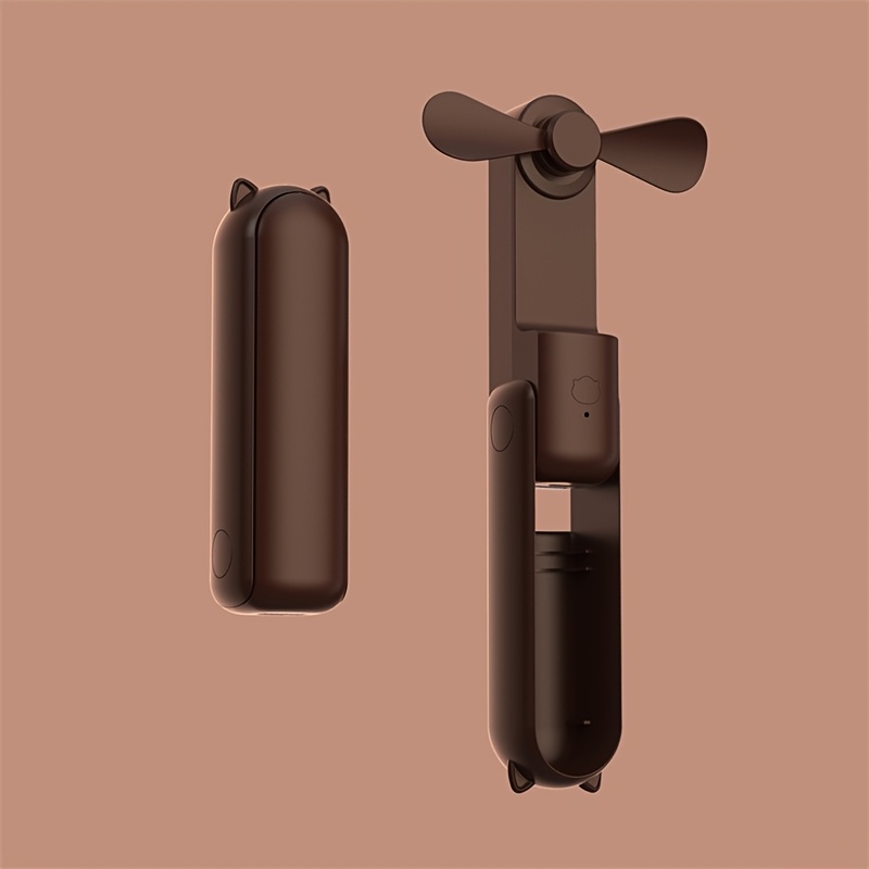 Un ventilateur portable qui double d'une banque d'alimentation, mini et pliable, silencieux pour une utilisation en dortoirs ou bureaux sur un bureau.