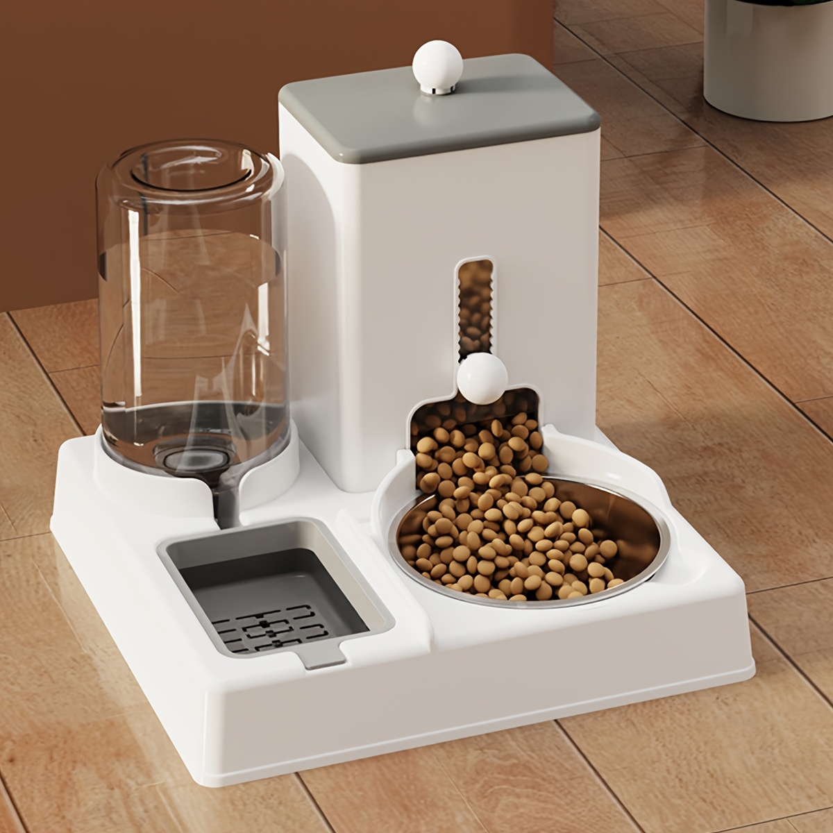 

A Pet Feeding Station With A Stainless Steel Bowl For Cats And Dogs, Featuring An Integrated Water And Food Dispenser, Without Battery