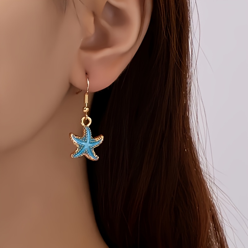 A Pair Of Bohemian Ocean-style Drop Earrings Featuring Oil- Starfish Pendants, Perfect For Beach Vacations And Everyday Wear