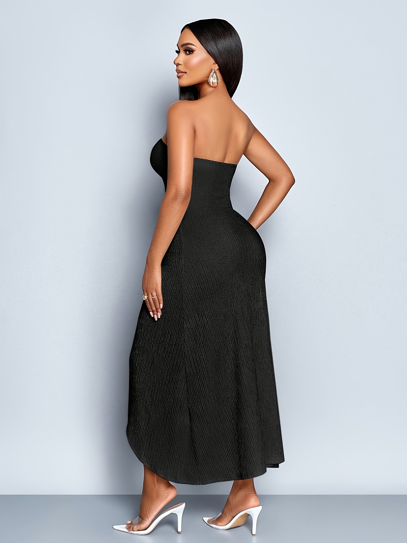 A Sleeveless, Strapless Dress with Hollow Metal Button Decorations, Featuring a Front Split And Made from Textured Fabric in a Light Color, Perfect for Casual Vacation Wear