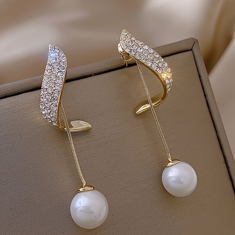 a pair of   shaped drop earrings for women featuring pendants and set with imitation stones   classic minimalist fashion for evening gowns casual parties and everyday gifts for women without battery