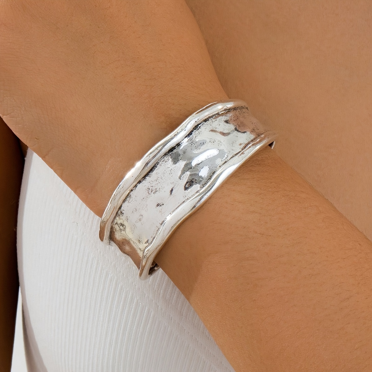 

A ' Silvery Wide Bracelet With An Exaggerated And Chunky Design