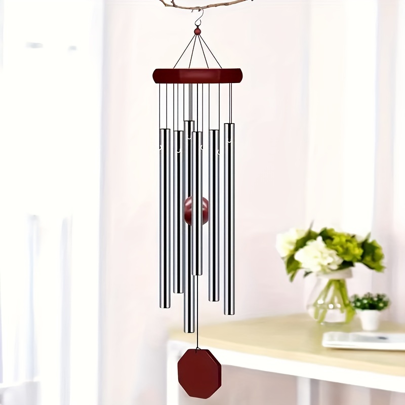 

Classic Wooden With 8 Sides And Golden Aluminum Tubes, A Home Decoration Made Of Wood With 6 Tubes Hanging As Ornaments.