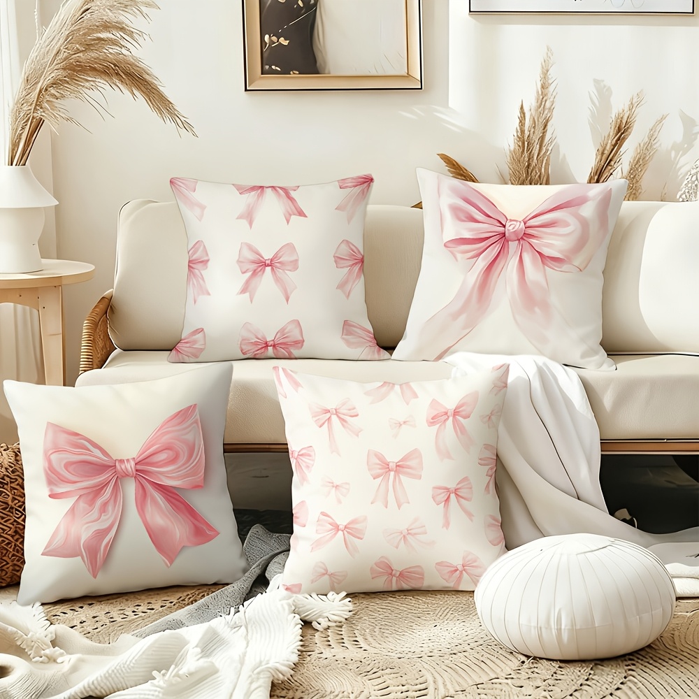 E-shop 4-teiliges Kissenbezug-Set mit rosa Schleife als Mittelpunkt. Unterschiedliche Designs umfassen dichte kleine Schleifenmuster Nahaufnahmen von