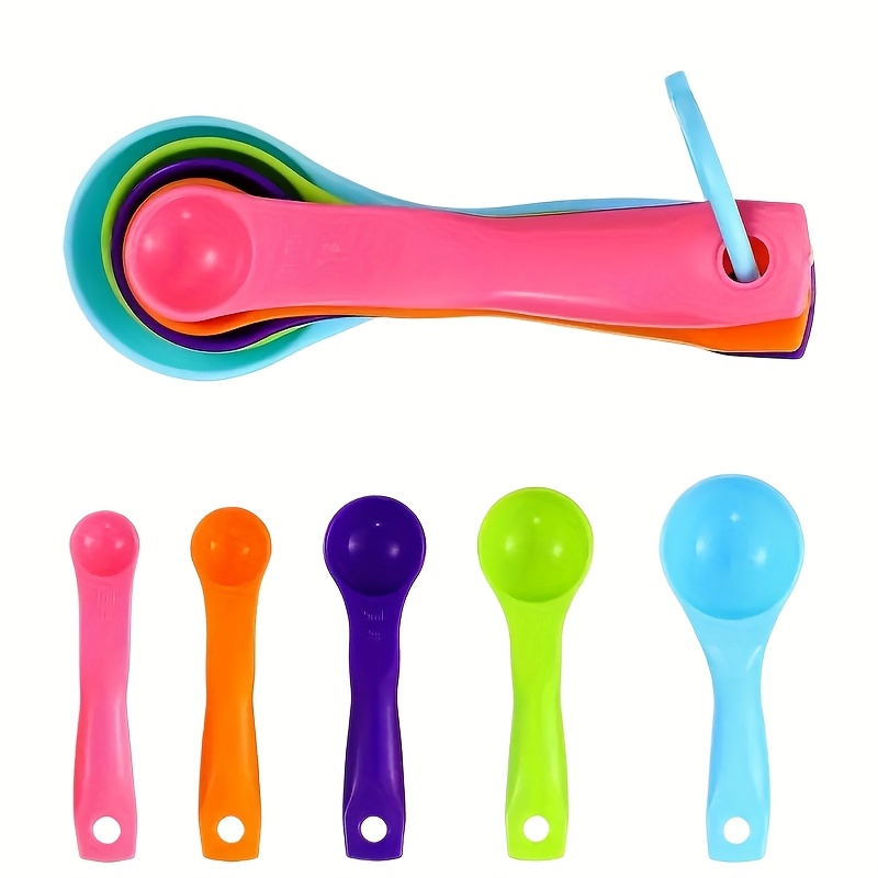 Un juego de vasos y cucharas medidoras de plástico, que incluye cinco cucharas apilables, ideal para mediciones precisas en la cocina y la repostería. Estos vasos medidores cuentan con un boquilla y mango, lo que los convierte en herramientas de cocina esenciales.