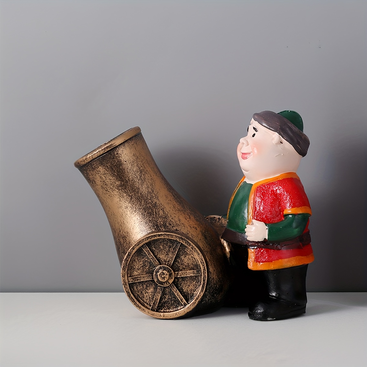 a resin figure of a chubby old man with a cannon suitable for decoration during eid celebrations Product details 9