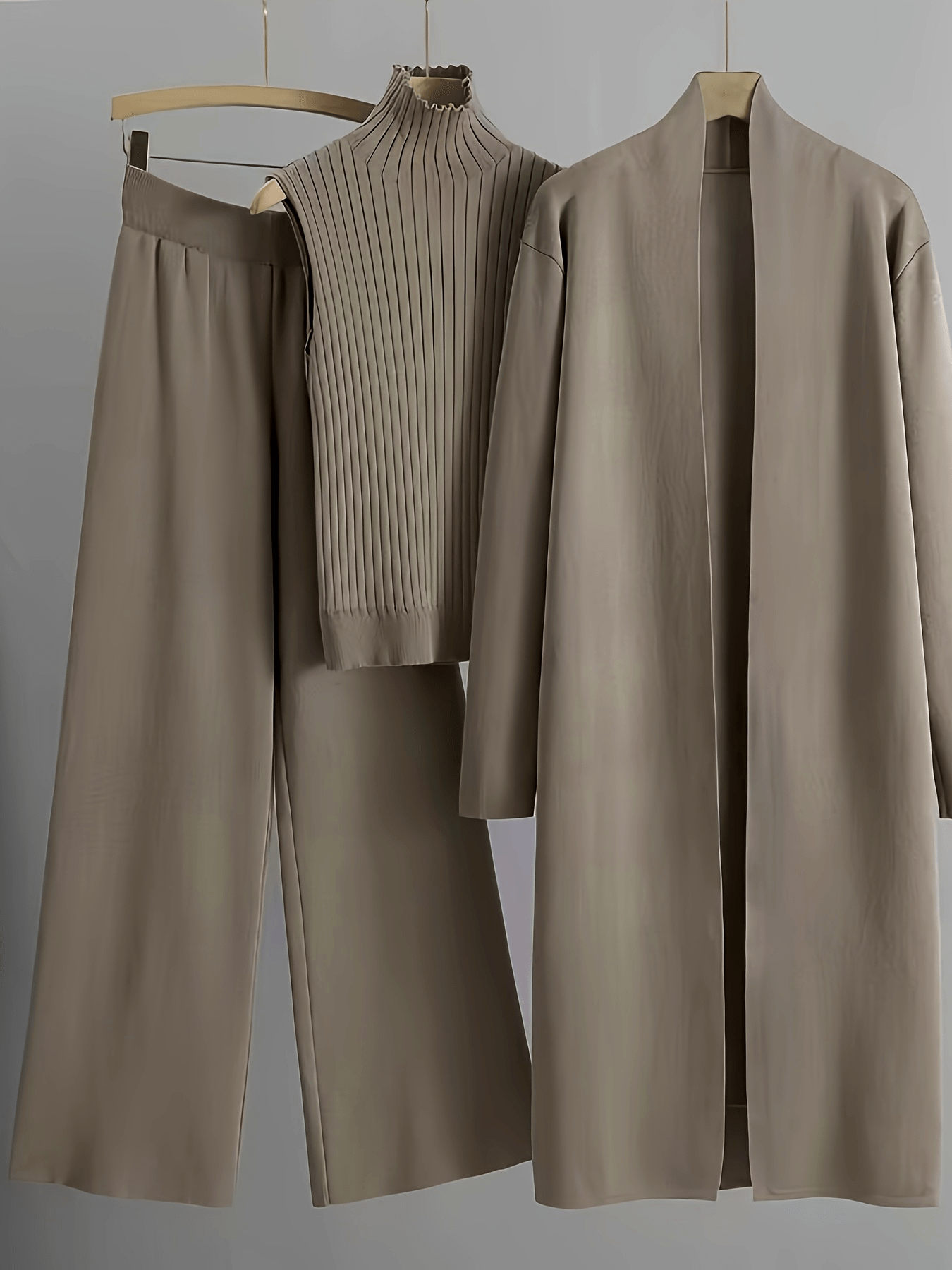 Newness Autumn Haze Knit Three Piece Set A stylish and cozy three piece knit set in a soft autumnal shade perfect for fall Featuring a comfortable sweater coordinating pants and a chic scarf
