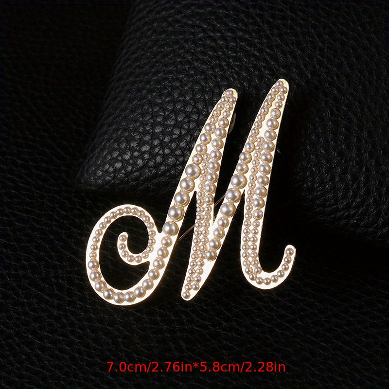 M brooch on sale