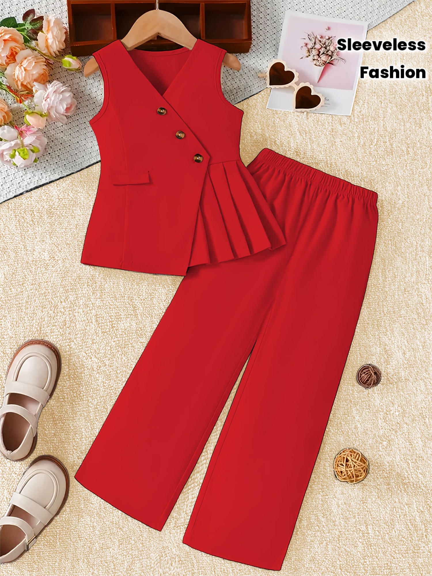 A Stylish Sleeveless Vest Top And Long Pants Set for Girls, Featuring Three Buttons on The Top And a Pleated Design on One Side of The Hem; The Pants Have a Wide-Leg Design with an Elastic Waistband. Suitable for Wearing in Spring, Summer