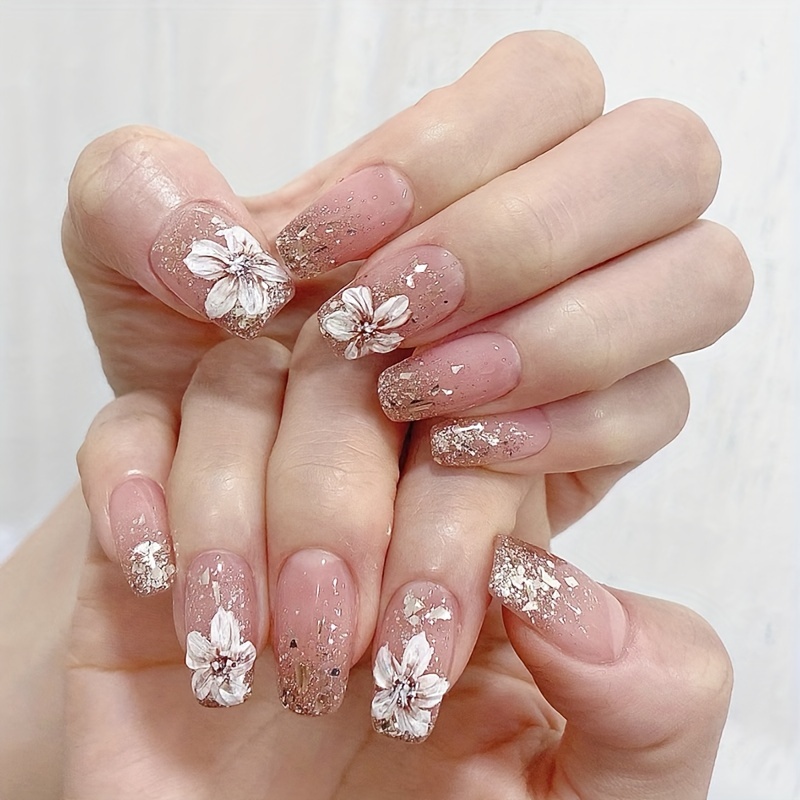 shiny flowers nudes shiny sparkling nude nails on the background of multi ...