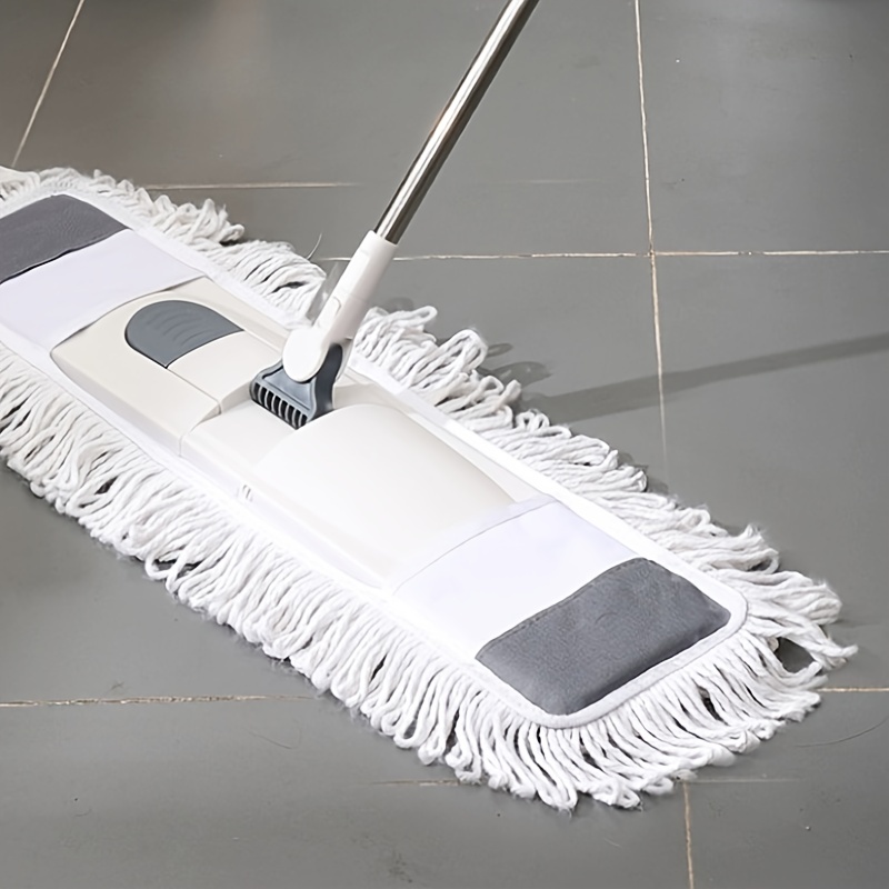 Close up man use a mop to mop the floor. Concept, household chore in daily  life. Hygienic and sanitary. Mop the dust, wipe the floor. Cleaning house.  Maintaining tile floors to be