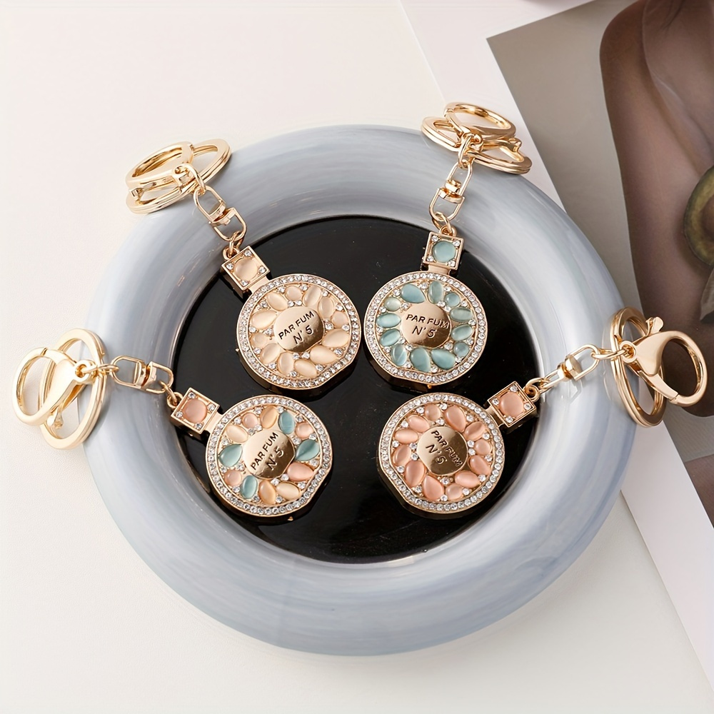 Cristal bouteille de parfum porte-clés pour femmes créatif diamant arc  métal porte-clés voiture sac pendentif petit cadeau bijoux accessoires