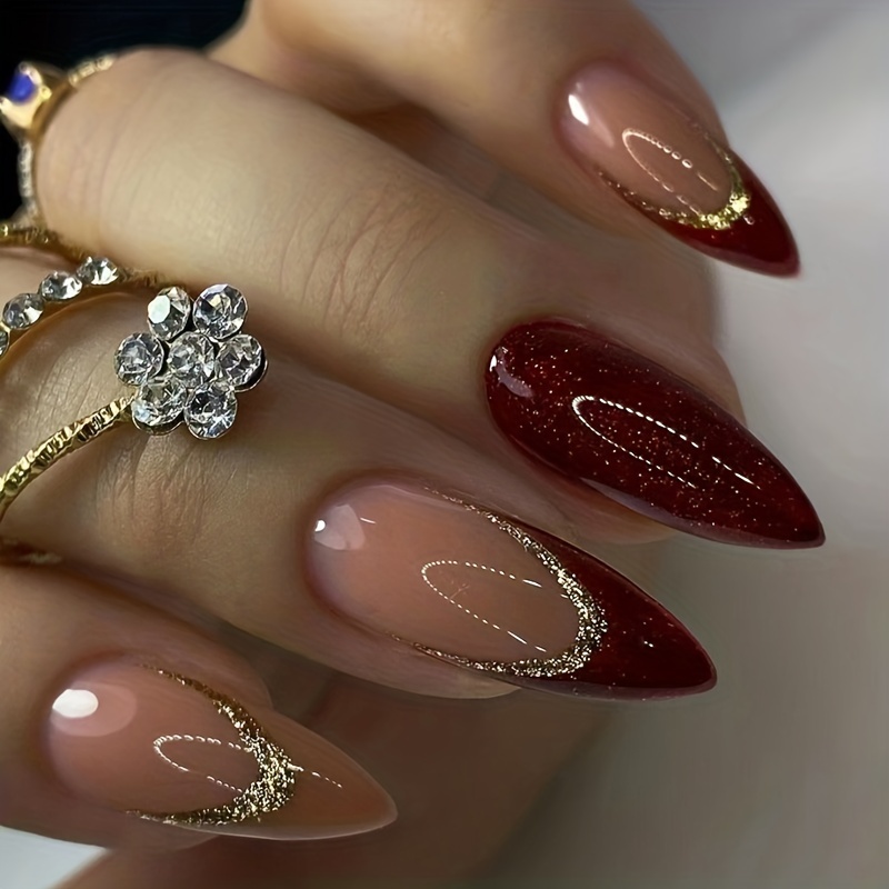 Woman hand with long nails and a bottle of dark red burgundy nail polish  Stock Photo - Alamy