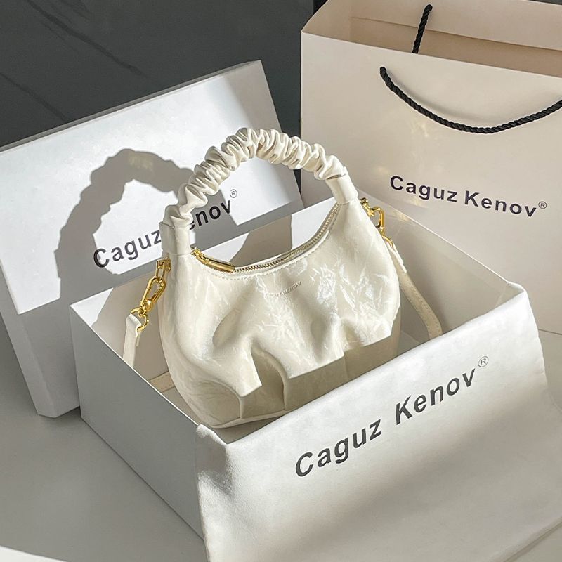 A Single Unit of The Latest Cloud Bag - a Small Pleated Clutch with an Adjustable Shoulder Strap, Featuring a Premium Matte End, Perfect for Everyday Use And Casual Events. This Compact Handbag Exudes Sophistication