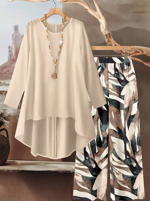 a two piece outfit featuring beige asymmetrical top with ink colored wide leg trousers a stylish yet comfortable look for vacations or daily commutes