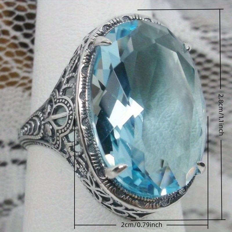 Luxury Hollow Pattern Inlay Oval Sea Blue Zirconia Ring