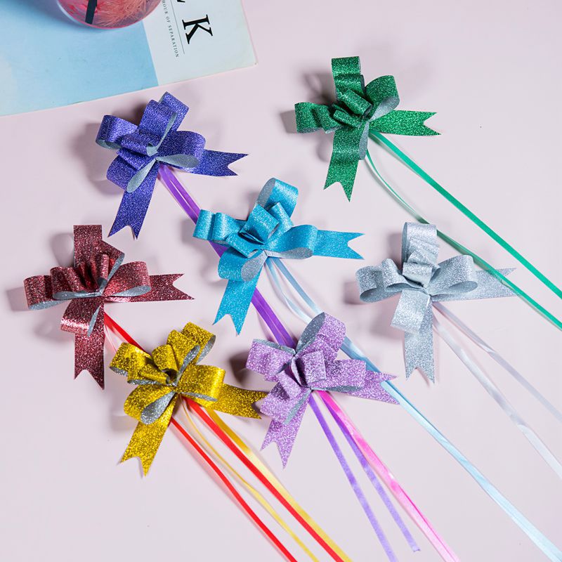 Small Gifts Wrapped in Floral Paper with Colorful Bows · Creative Fabrica