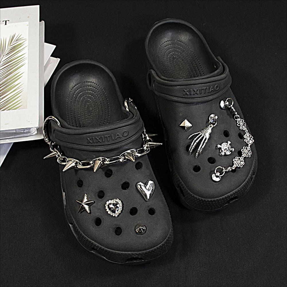 An  shop is selling black GOTH Crocs with studs, spikes, and chains for  $260