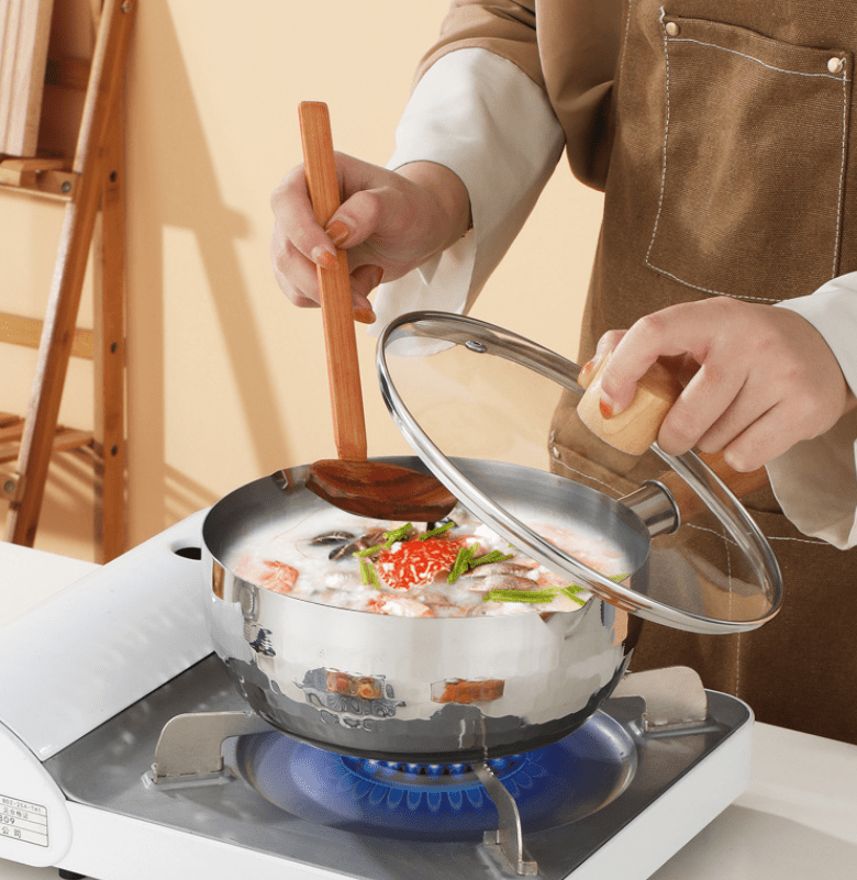 Pot with boiling soup or sauce, saucepan with open lid. Cooking