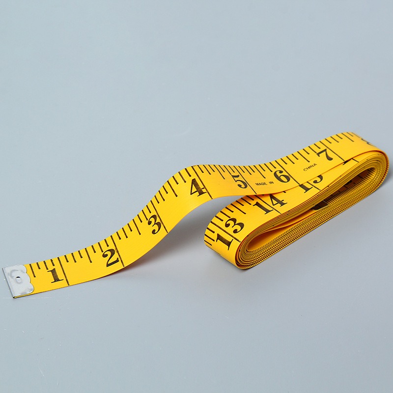 Yellow Tape Measure On A White Background For Measuring Clothing