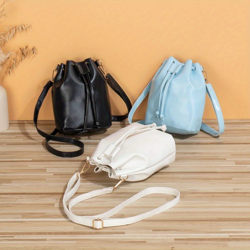 

Elegant Women's Crossbody Bucket Bag - Large Capacity, Solid Black, Light Blue, White - Sleek With Drawstring Closure, Leather