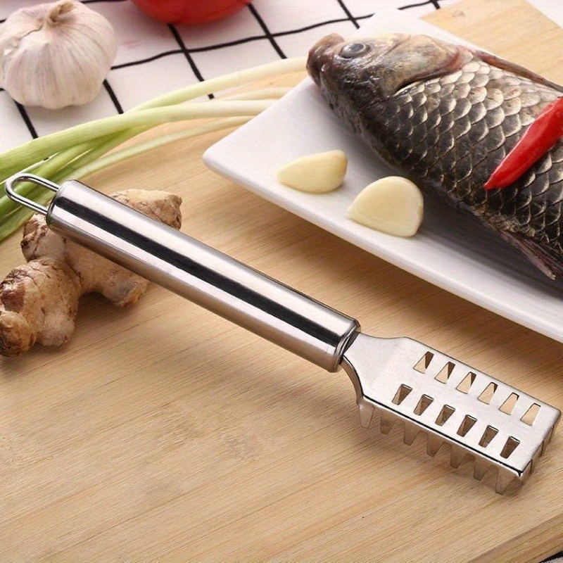 Image of A Single Fish Scale Remover Designed For Home Use, Made Of Stainless Steel, Ideal For Scraping Off Fish Scales. This Tool Serves As A Brush For Preparing Fish