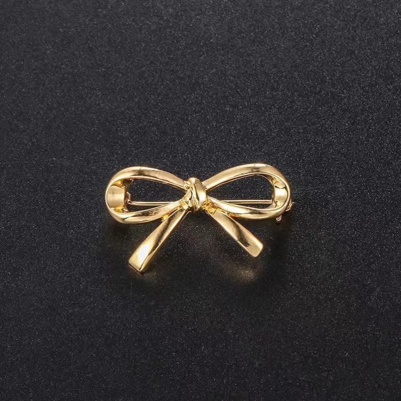 A Unique Metallic Bow Brooch Designed For, Featuring An Anti-walking And A -neck Pin In Style