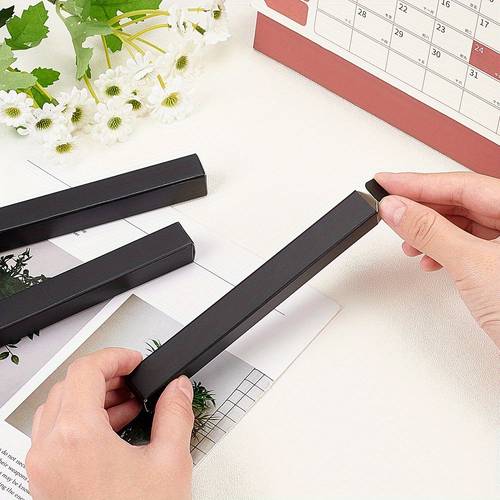 a box containing 60 rectangular paper containers designed for packaging pencils measuring 14 5x1 7x1 7 cm in black