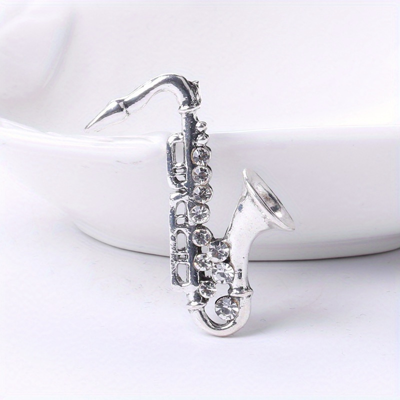TEMU 1 broche motif saxophone, badge en cristal artificiel brillant, design simple et créatif, pour hommes et femmes, tenue de travail, festival,