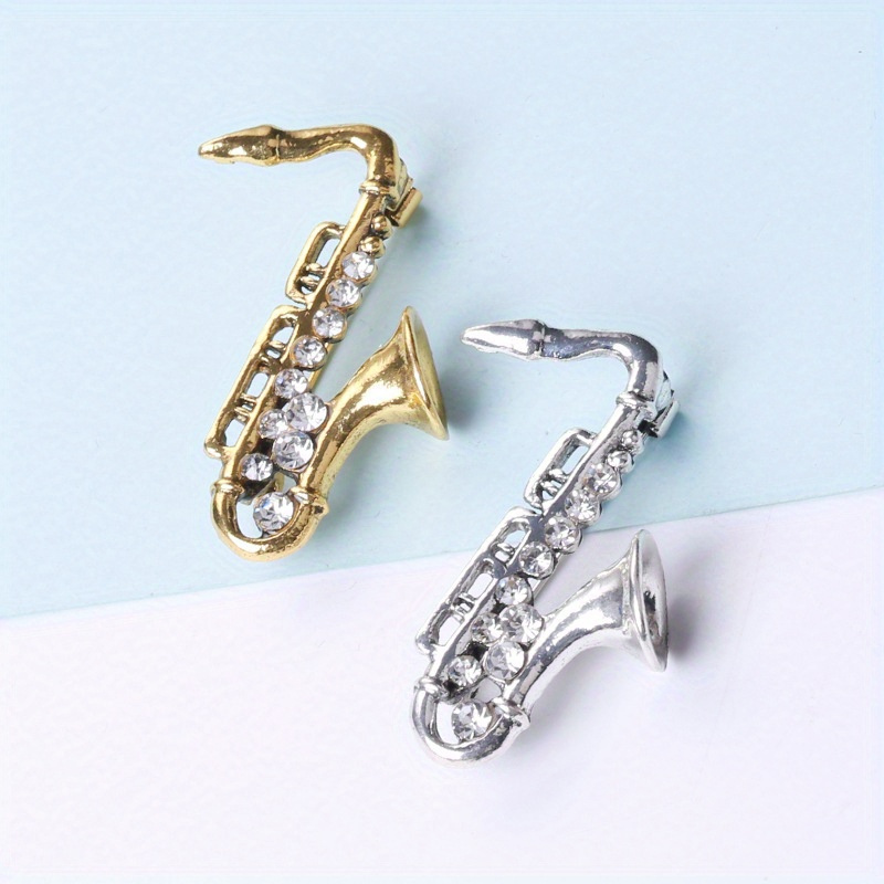 

1pc Saxophone Pattern Brooch, Shining Artificial Crystal Badge, Simple And Creative Design, For Men And Women Work Festival Party Daily Wear