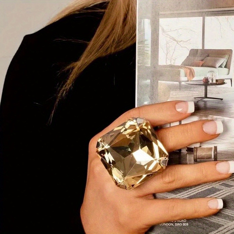 

A Colorful Square Ring With A Simple And Unique Water Design, A Stylish Accessory.