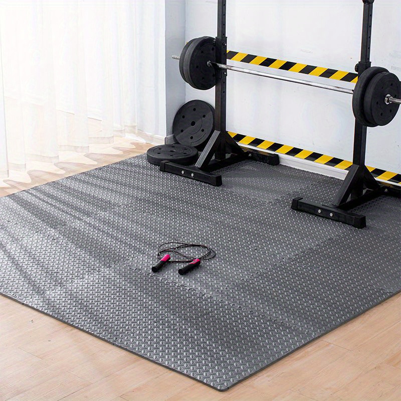 A workout equipment standing on a gray gym flooring mat