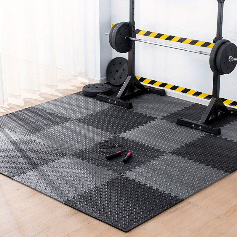 Workout equipment standing on a gym flooring mat