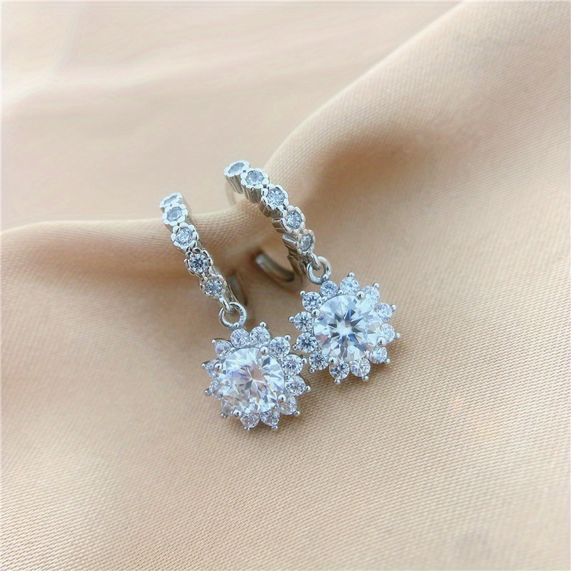 Image of Sunflower Earrings Feature A 1-carat Moissanite Set In 925 Silver, Perfect For Women To Wear , Engagements, Or As Bridal Additions. Are Packaged In A Gift Box And Weigh Around 4 Grams