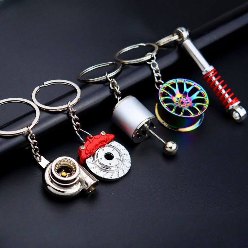 

5-piece Creative Metal Keychains With , Gear Shift, Wheel , Brake Disc & Shock Designs - Key Rings For Auto Enthusiasts, Assorted Colors