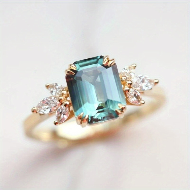 Teal Emerald Cut Zirconia Ring with Accents