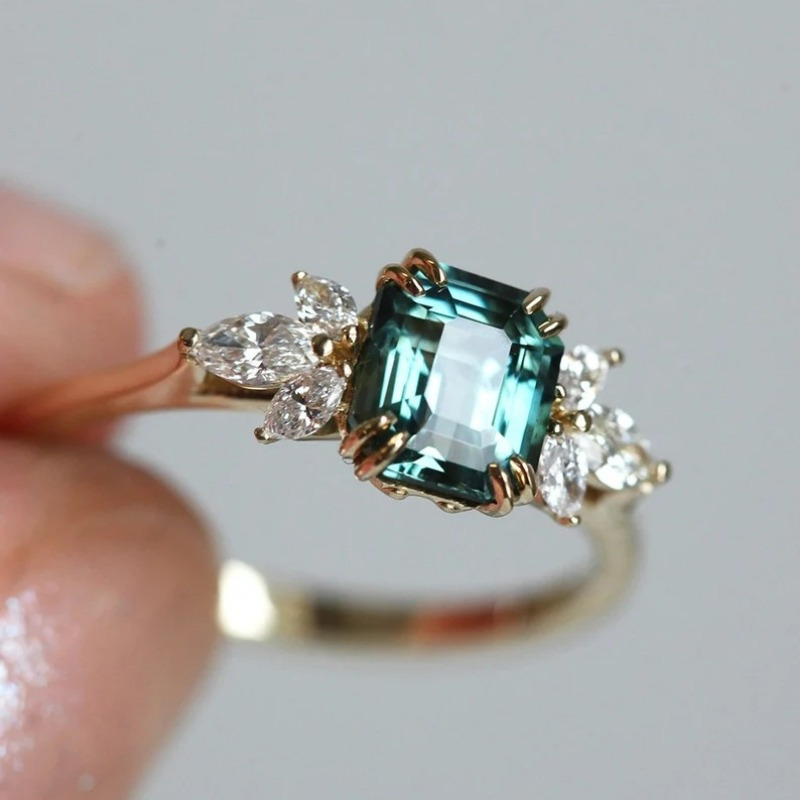 Teal Emerald Cut Zirconia Ring with Accents