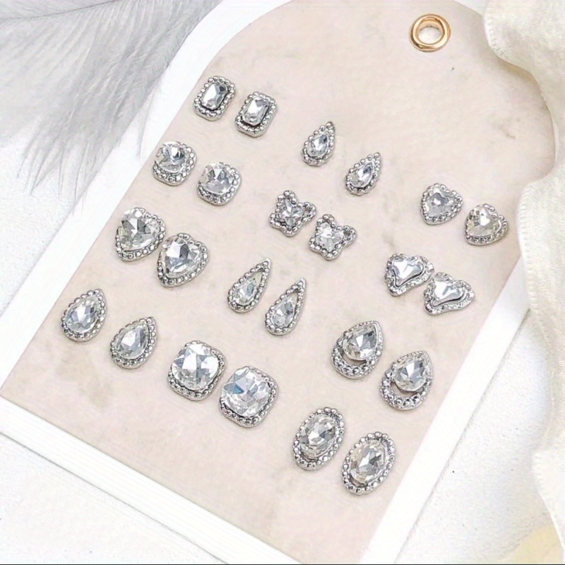 

12pcs Luxury Alloy Nail Art Charms, Hypoallergenic, Assorted Shapes With White Rhinestones, Silvery Octagon, Heart, Teardrop, And Square For Nail Decorations